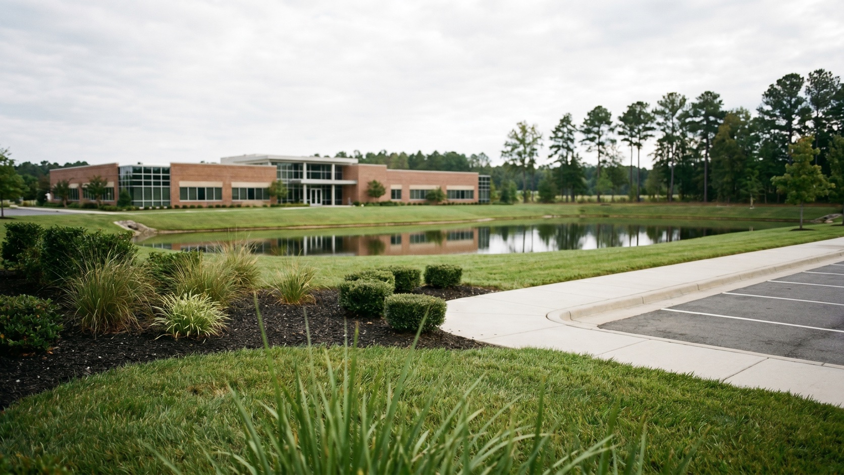 Polished commercial office exterior with manicured landscaping in the Glen Allen area at golden hour